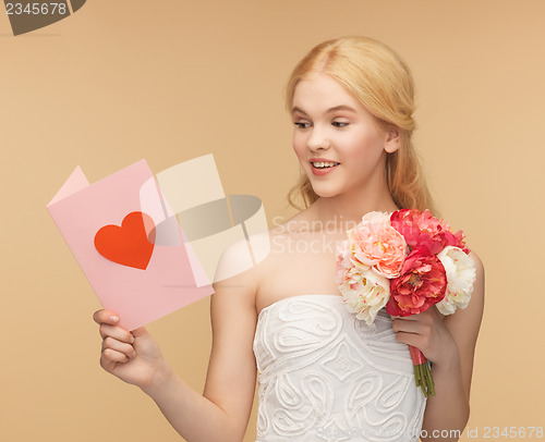Image of young woman holding flower and postcard