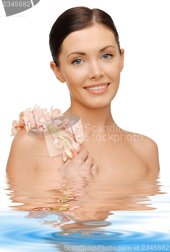 Image of lovely woman with orchid flower