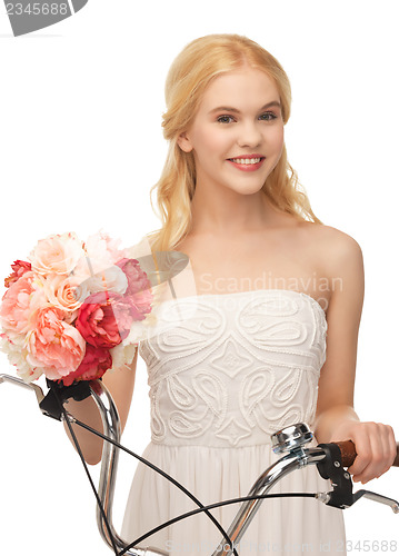 Image of country girl with bicycle and flowers