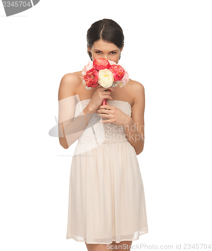 Image of woman smelling bouquet of flowers