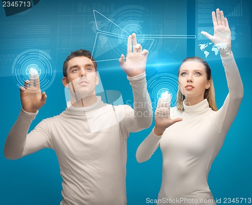 Image of man and woman working with virtual screens