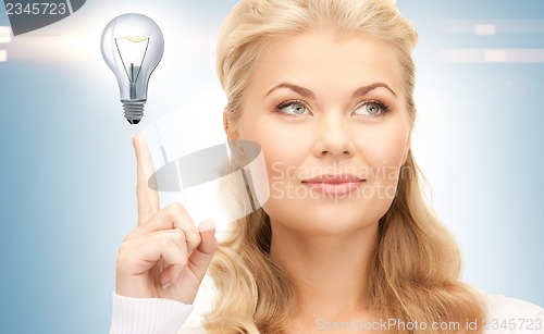 Image of woman pointing her finger at light bulb