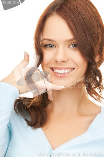 Image of woman making a call me gesture