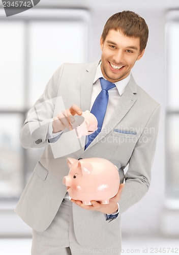 Image of man with two piggy banks