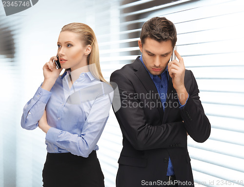 Image of man and woman with cell phones