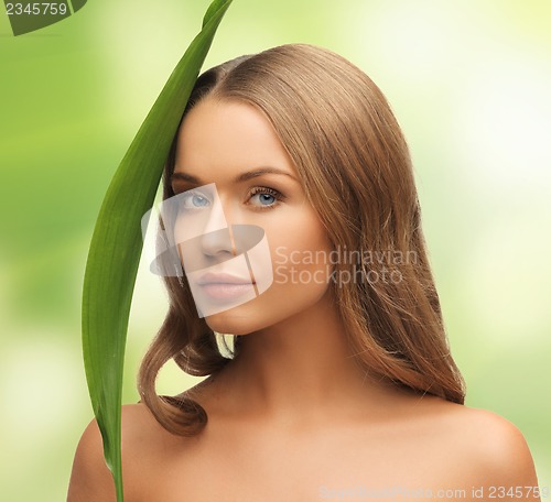 Image of woman with green leaf