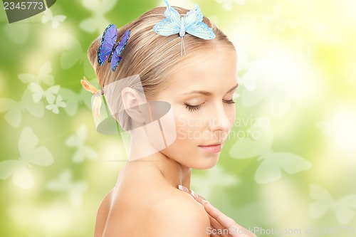 Image of beautiful woman with butterfly in hair