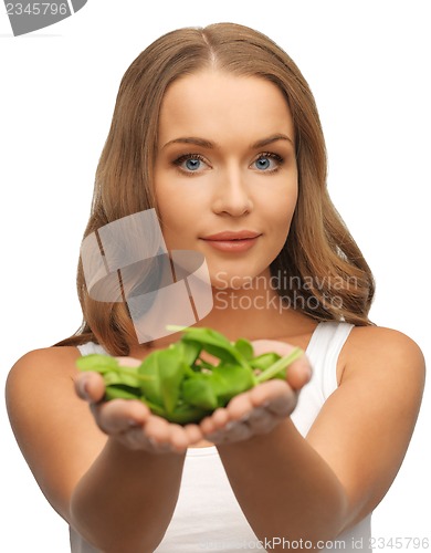 Image of woman with spinach leaves on palms