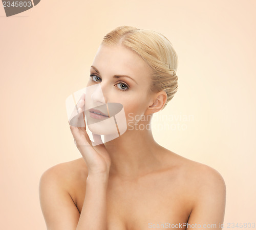 Image of woman touching her face