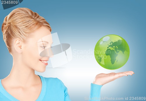 Image of woman holding green globe on her hand