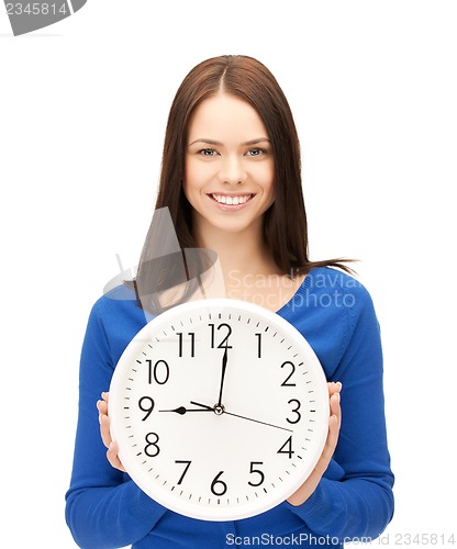 Image of businesswoman with wall clock