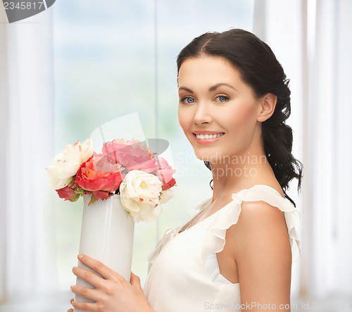 Image of woman with vase of flowers