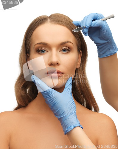 Image of woman face and beautician hands