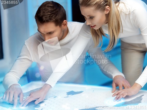 Image of man and woman working with something