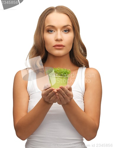 Image of woman with green grass in pot