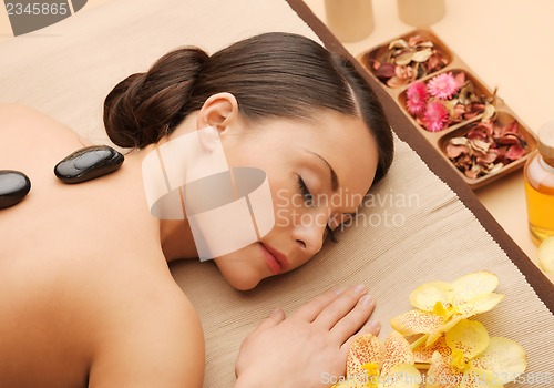 Image of beautiful woman with hot stones