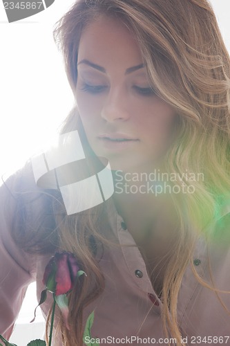 Image of beautiful woman with rose