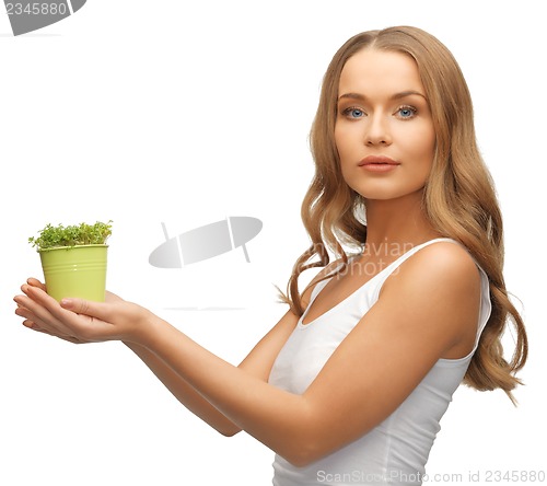 Image of woman with green grass in pot