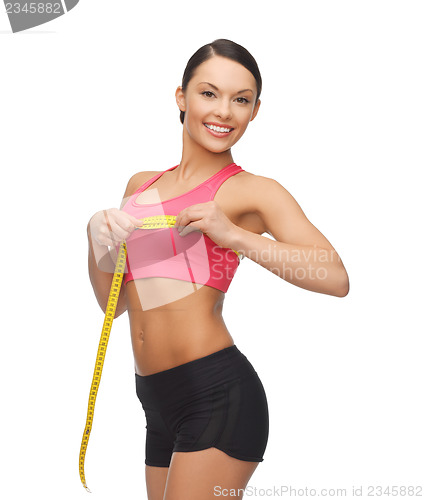 Image of sporty woman measuring her breast