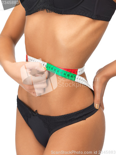 Image of woman measuring her waist