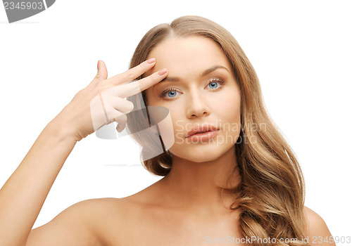 Image of beautiful woman pointing to forehead