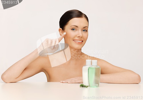 Image of beautiful woman with moisturizing creme drop