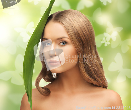 Image of woman with green leaf and butterflies