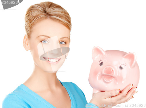 Image of lovely woman with piggy bank