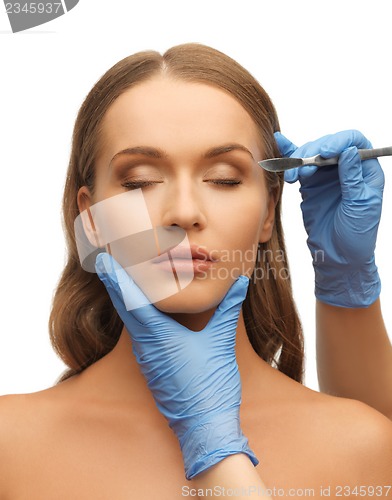 Image of woman face and beautician hands