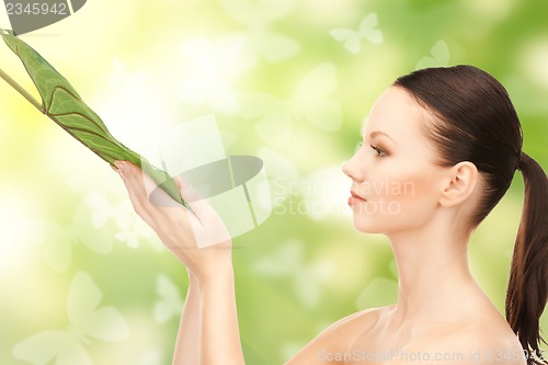 Image of woman with green leaf