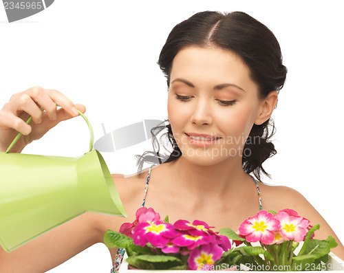 Image of housewife with flower in pot and watering can