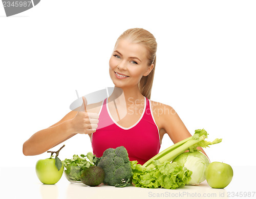 Image of woman shows thumbs up with organic food