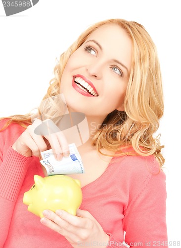 Image of woman with piggy bank and cash money