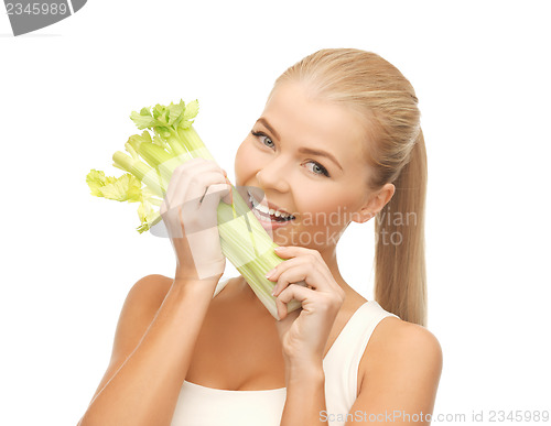 Image of woman biting piece of celery or green salad