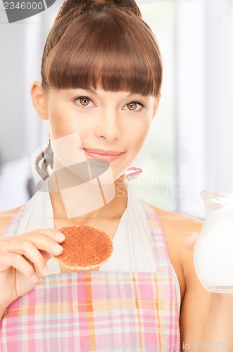 Image of housewife with milk and cookies