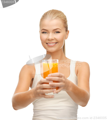 Image of woman holding glass of orange juice