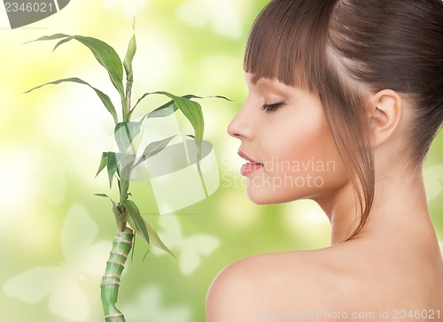 Image of woman with sprout and butterflies