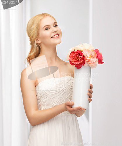 Image of woman with vase of flowers