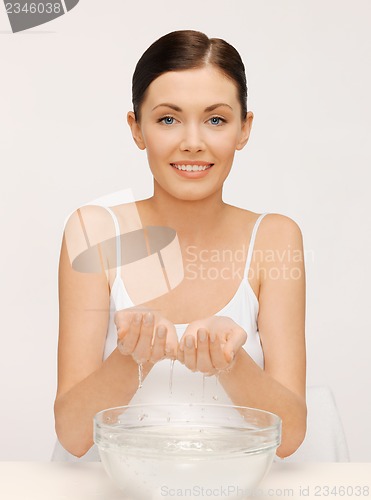 Image of woman washing her face