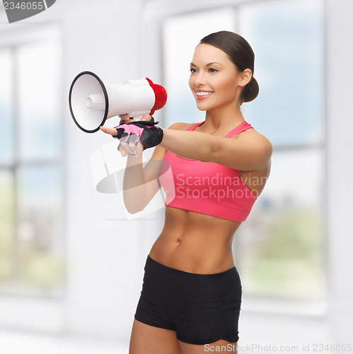 Image of woman with megaphone pointing at something