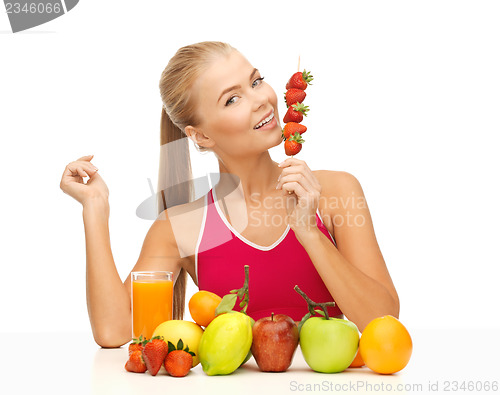 Image of woman with organic food eating strawberry