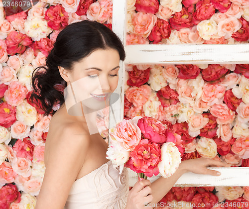 Image of woman with old ladder and background full of roses
