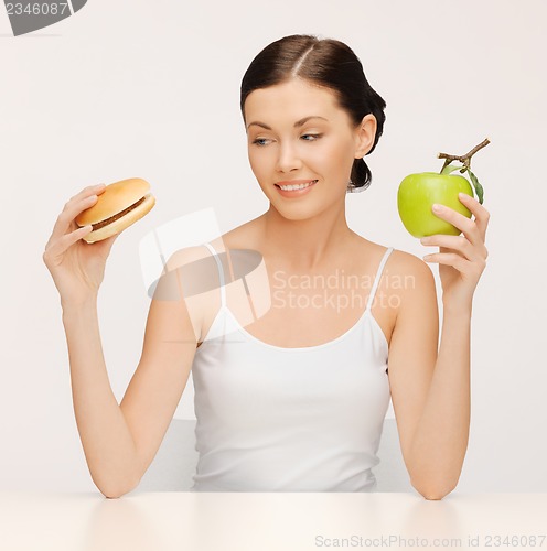 Image of woman with hamburger and apple