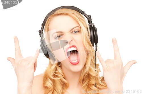 Image of woman with headphones showing rock n roll sign