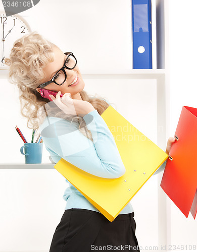 Image of woman with folders and cell phone