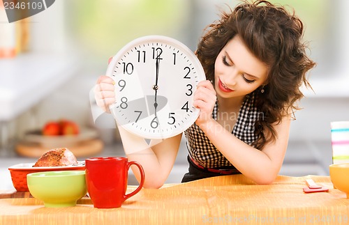 Image of young attractive woman in the kitchen