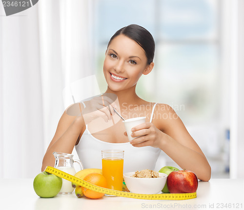 Image of woman with healthy breakfast and measuring tape