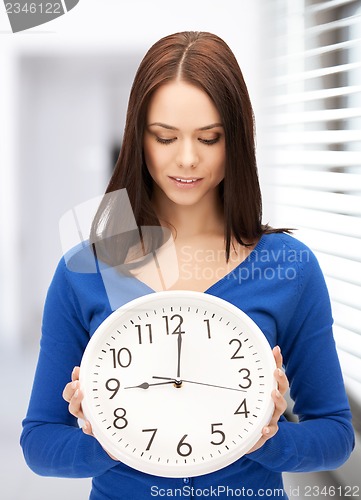 Image of woman holding big clock