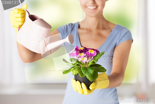 Image of woman holding pot with flower