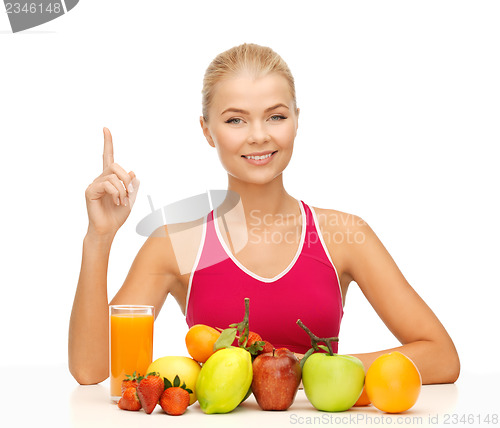 Image of woman with juice and fruits holding finger up